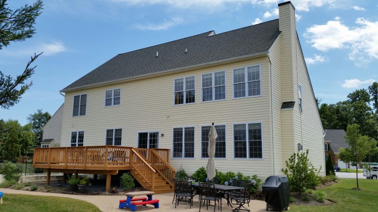 Clean shingle roof and deck on a two-story home